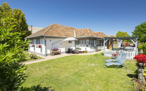 Sunny: Sky, Roof, House, Shrub, Home, Cottage, Residential Area, Land Lot, Rural Area