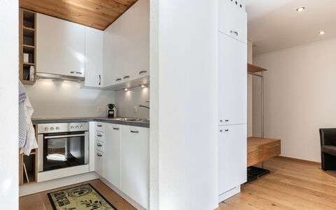 Atlantis Apartments by Mein Samnaun – Mo: Flooring, Interior Design, Floor, Wood, Furniture, Kitchen Appliance, Kitchen, Ceiling, Major Appliance, Wood Flooring