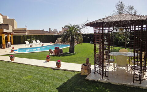 L'Aldea: Property, Grass, Backyard, Building, Leisure, Real Estate, Lawn, House, Swimming Pool, Resort