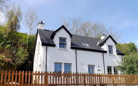 Staffin Road: Sky, Cloud, Building, Window, Property, Plant, Fence, House, Picket Fence, Tree