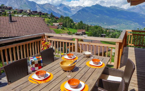D'Arby: Table, Sky, Building, Cloud, Furniture, Property, Mountain, Tableware, Chair, Wood