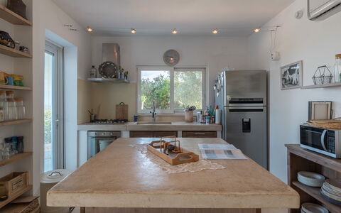 Villa Butterfly: Countertop, Furniture, Property, Cabinetry, Table, Wood, Kitchen, Window, Interior Design, Shelf