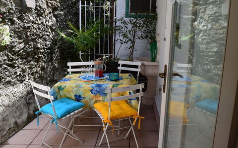 Piazzetta: Table, Furniture, Plant, Chair, Flowerpot, Azure, Building, Outdoor Table, Outdoor Furniture, Interior Design