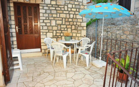 Brač Sutivan 111: Table, Furniture, Property, Plant, Building, Umbrella, Chair, Outdoor Table, Wood, Flowerpot